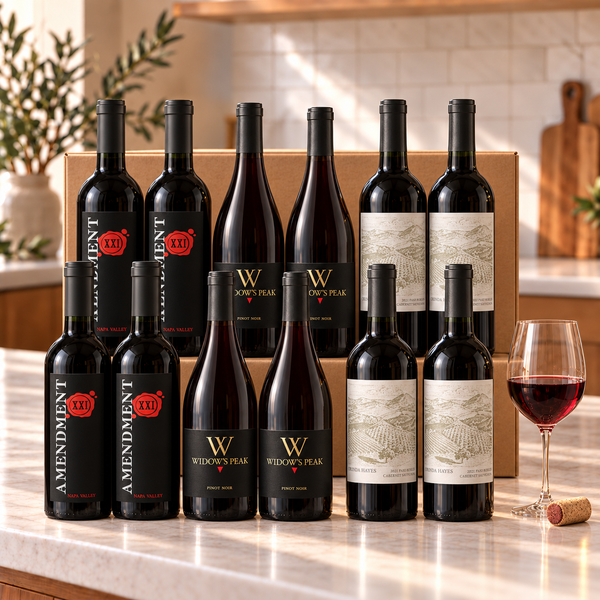 Illustrative 12-bottle red wine selection on a kitchen counter
