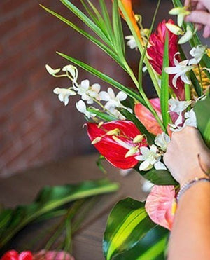 tropical flowers being spread by a woman