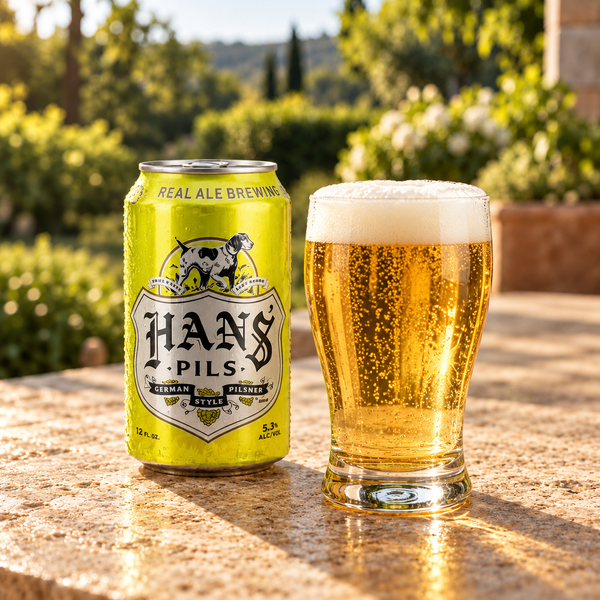 Illustrative pilsner can beside a glass of golden beer on a sunlit outdoor counter