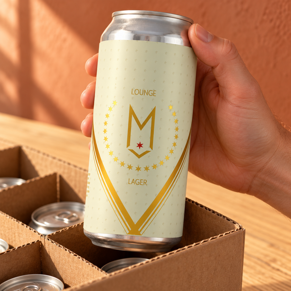 Hand lifting a Maplewood Lounge Lager can from a cropped carton; illustrative selection