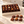 Illustrative open Chocolate of the Month Club box on a countertop with six chocolates set beside it
