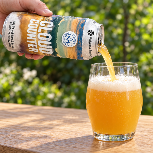 Illustrative close-up of hands pouring hazy IPA from a Cloud Counter can