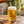 Golden beer poured into a dimpled mug on an outdoor wooden table
