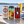 Illustrative selection of three craft pilsner and lager cans beside golden beer on a waterside table