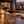 Illustrative red wine being poured into a stemmed glass at an evening dining table