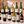 Illustrative twelve distinct international wines, six red and six white, on marble; actual selections vary