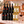 Illustrative twelve-bottle mixed red and white wine selection on a marble platform with a matching Wine of the Month Club shipping box