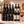 Illustrative twelve-bottle red wine selection on a rectangular marble platform with a branded shipping box behind the bottles