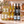 Illustrative 12-bottle white wine selection on a rectangular marble platform with a branded shipping box behind the bottles