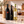 Illustrative 3-bottle mixed red and white wine selection on marble with Wine of the Month Club branded shipping box behind the bottles