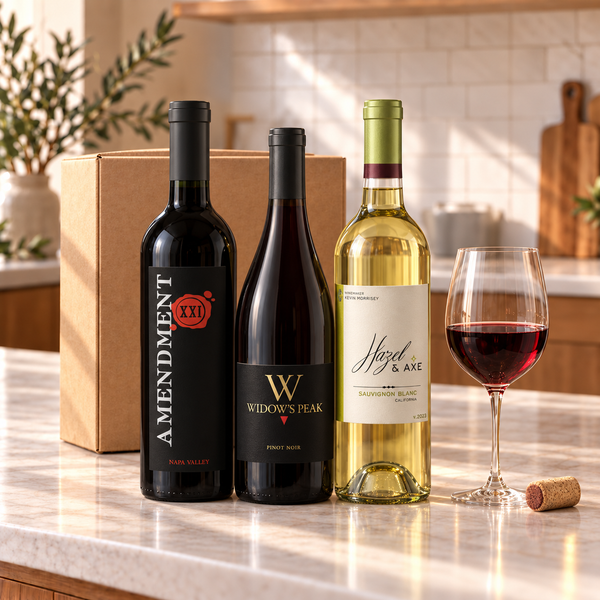 Illustrative 3-bottle mixed red and white wine selection on a kitchen counter