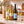 Illustrative 3-bottle white wine selection on marble with Wine of the Month Club branded shipping box behind the bottles