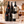 Illustrative 6-bottle red wine selection on marble with Wine of the Month Club branded shipping box behind the bottles