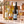 Illustrative 6-bottle white wine selection on a rectangular marble platform with a branded shipping box behind the bottles