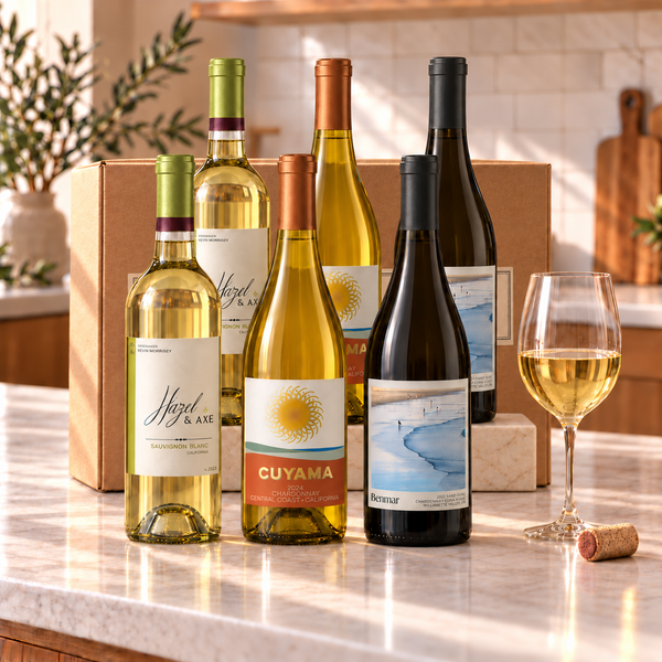 Illustrative 6-bottle white wine selection on a rectangular marble platform with a branded shipping box behind the bottles