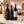 Illustrative three-bottle red wine selection on marble with Wine of the Month Club branded shipping box behind the bottles
